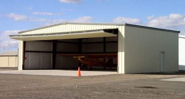 steel airplane hangar with bifold door