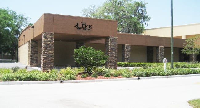 church metal building with brick and stucco finish with porte-cochere