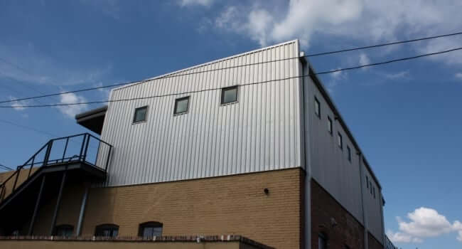 custom metal building atop historic brick retail store