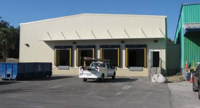 steel building with loading dock covered by custom canopy