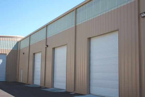 commercial warehouse with continuous light transmitting panels installed on wall at eave