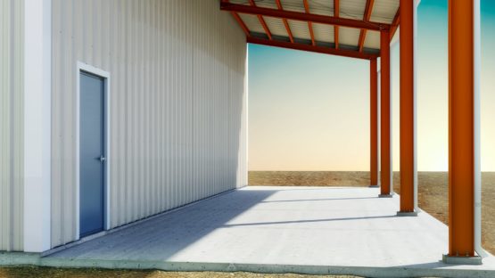 Steel building formed base trim on building with open leanto with recessed slab.